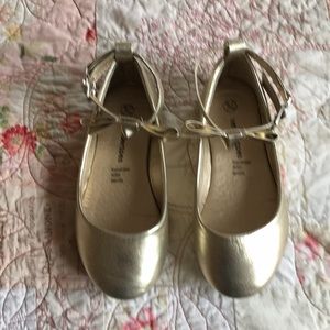 Little girl's gold shoe.